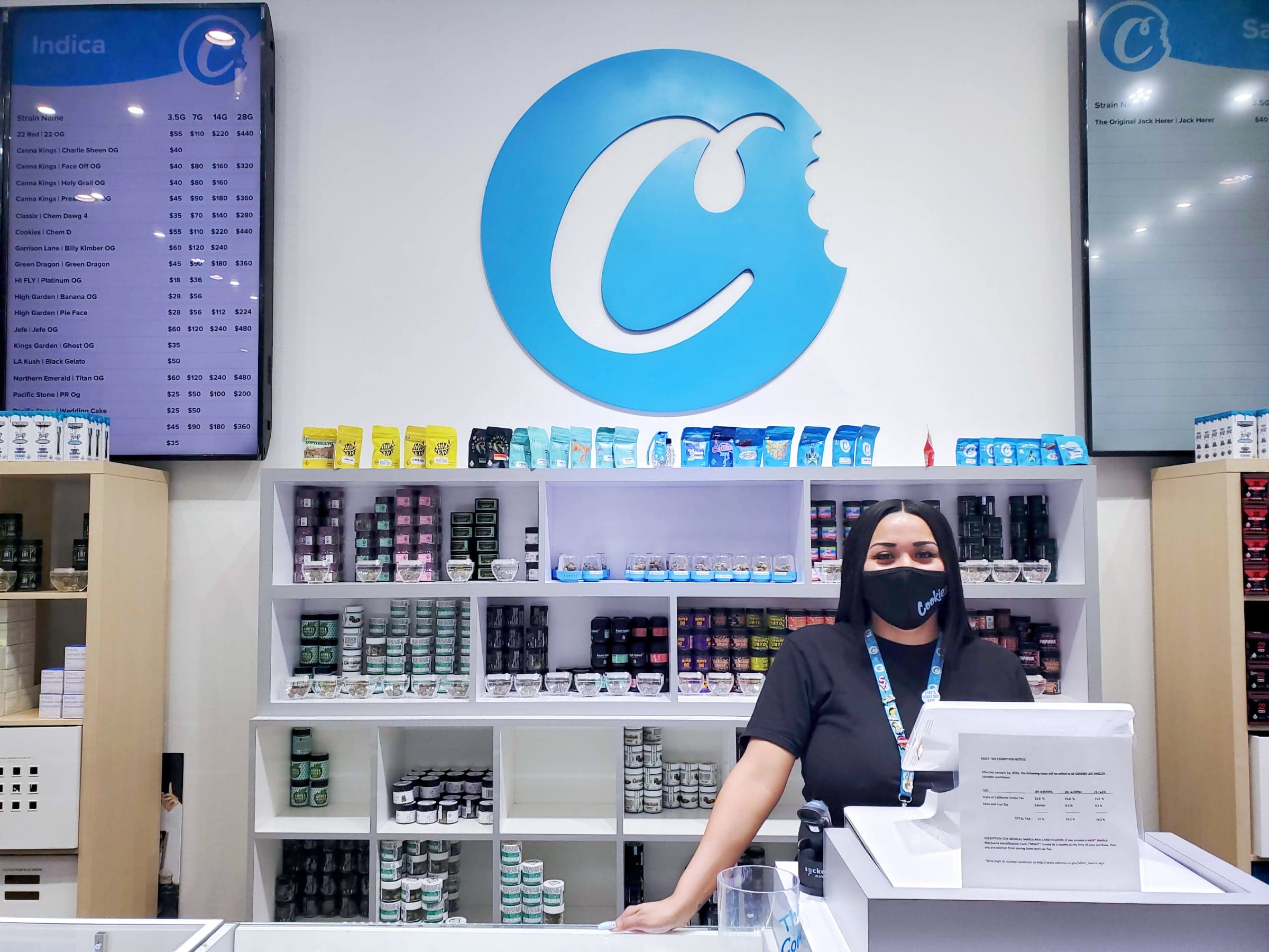 Budtender behind the register at the Cookies dispensary