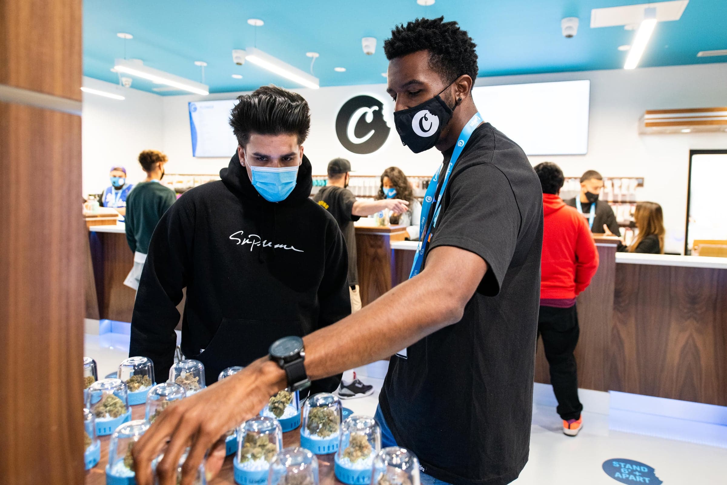 A dispensary employee grabbing a jar