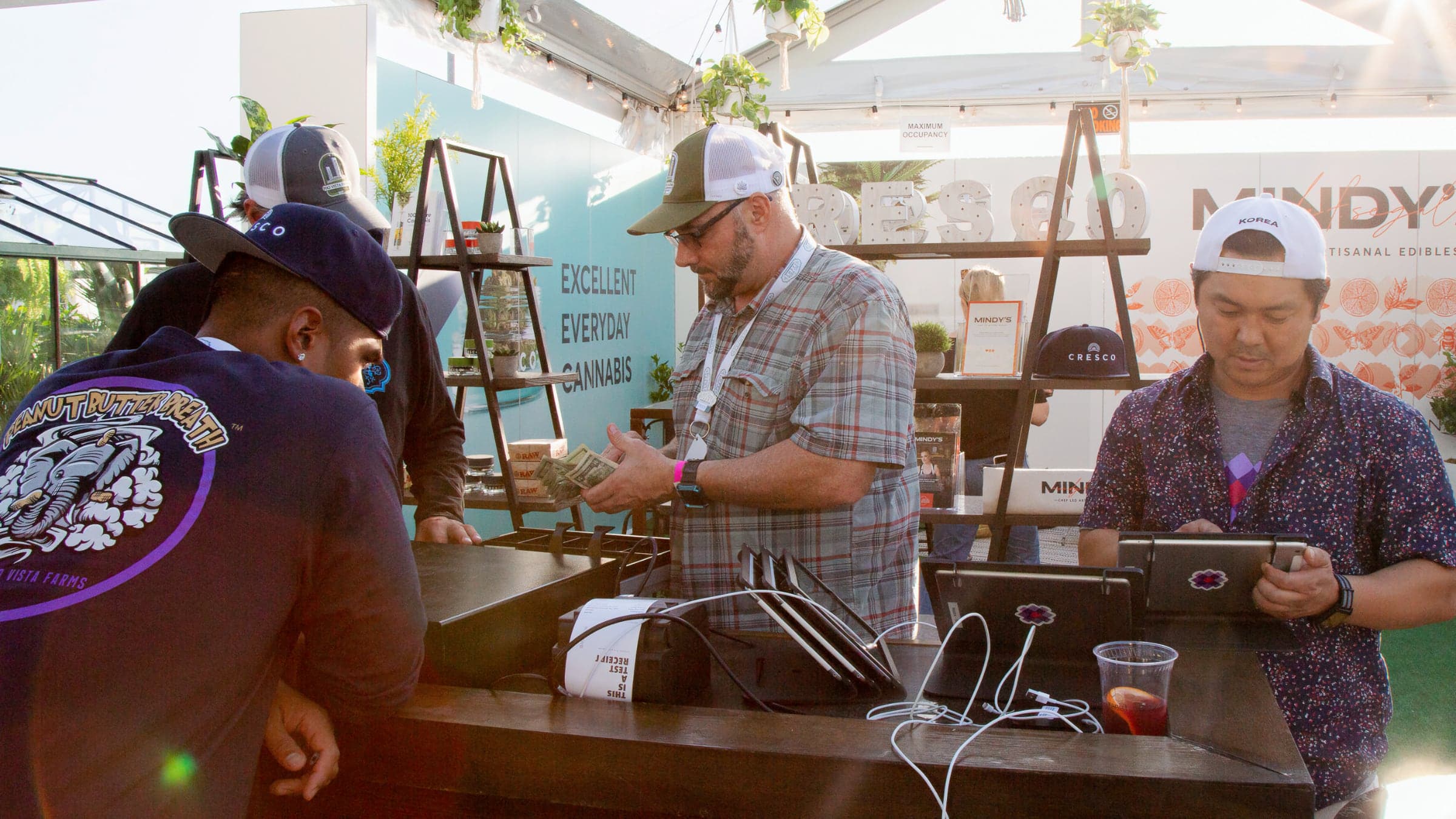 A Meadow customer service representative helps a dispensary owner get his POS