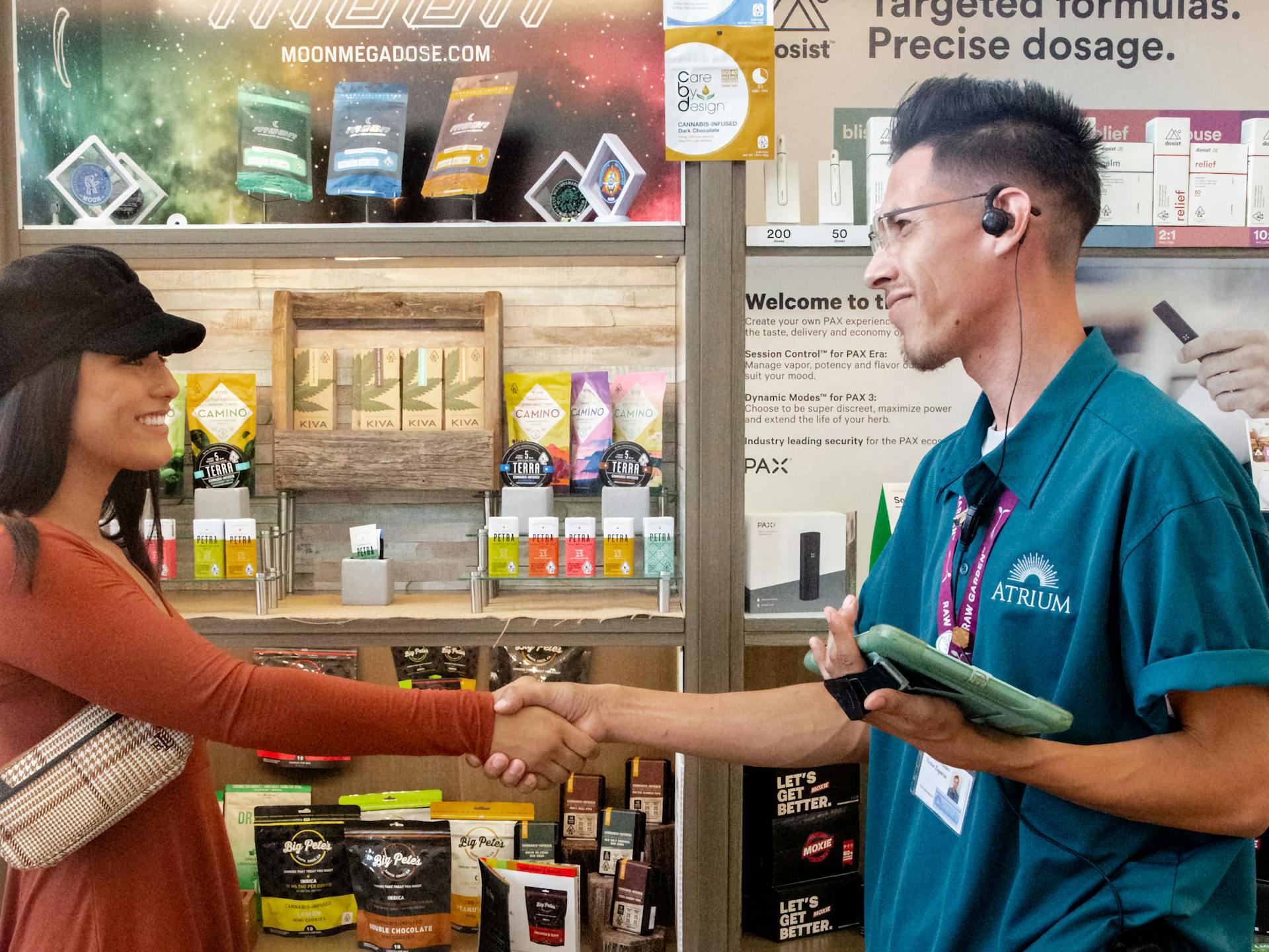 A budtender greets a customer inside the Atrium dispensary in Topanga