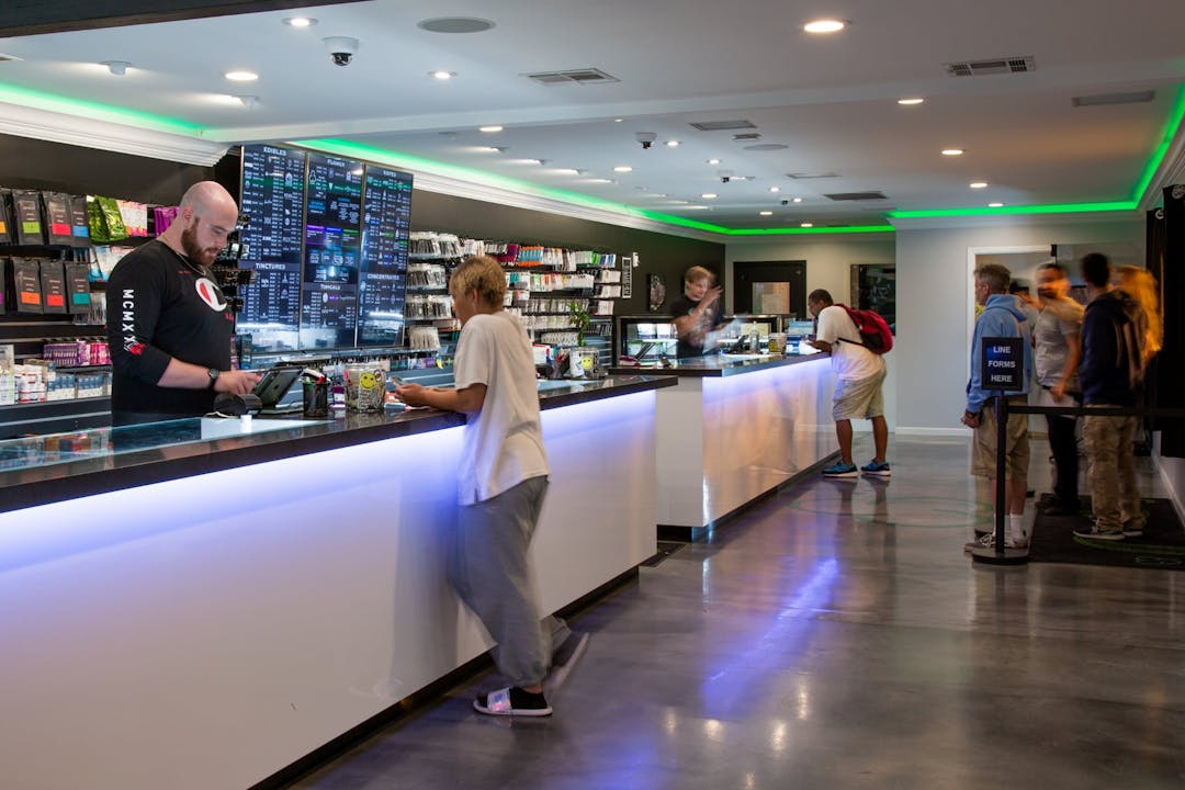 A budtender at Coast to Coast Canoga Park uses the cannabis POS to complete a transaction
