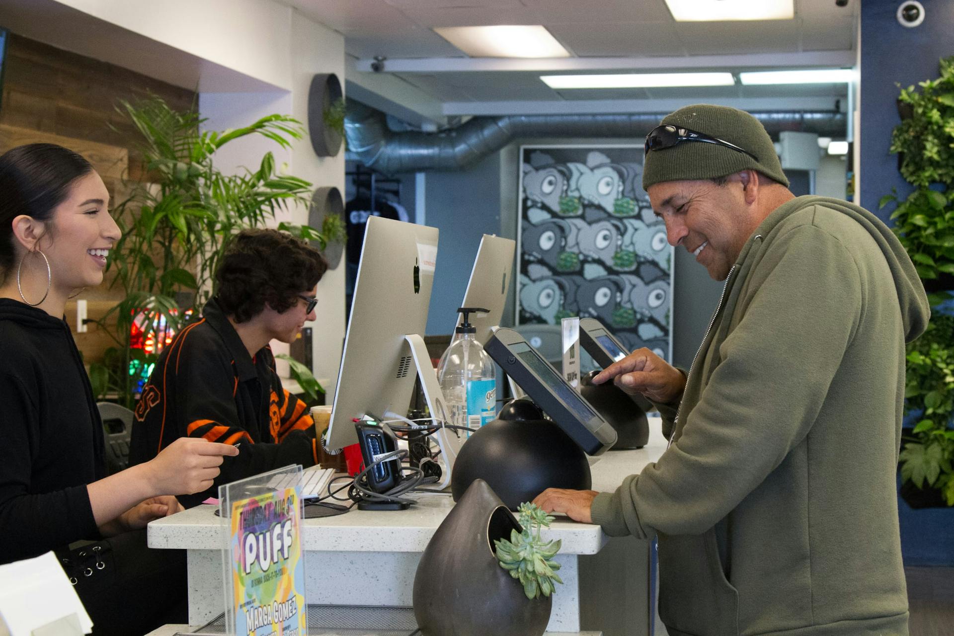 A happy budtender and a happy customer