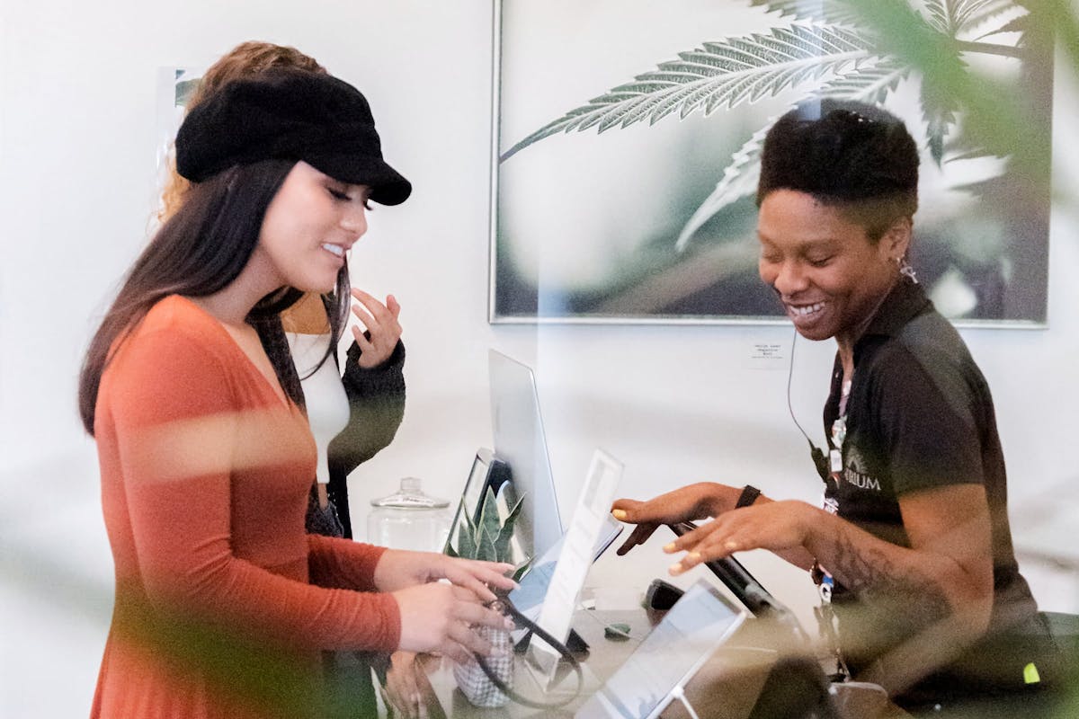 An Atrium dispensary employee helps a customer at the iPad register