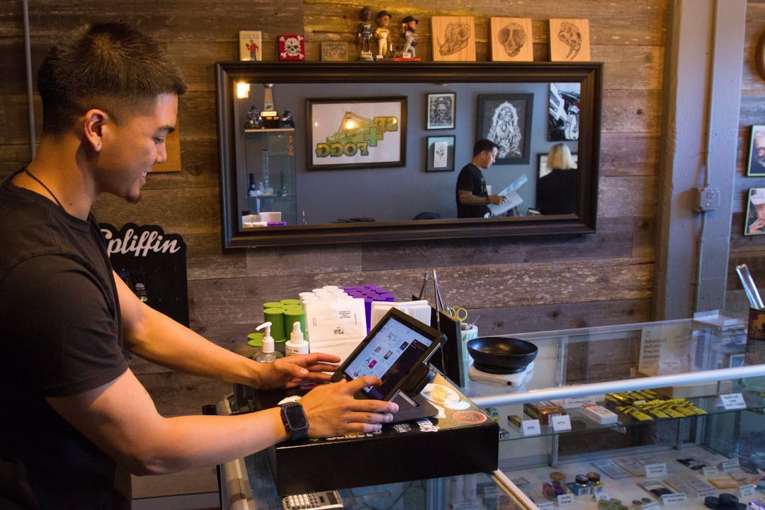 A budtender inputs an order into the Meadow cannabis POS