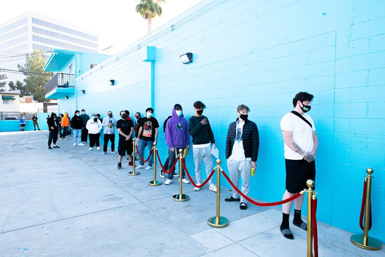 A long line outside a blue-walled dispensary