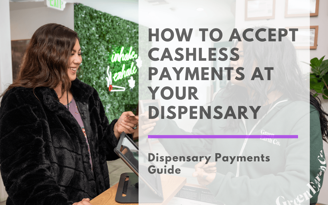 A smiling customer and a friendly budtender complete a cashless transaction inside a modern dispensary. The budtender, wearing a dark green "Green Earth Co." hoodie, hands a small product to the customer, who is dressed in a black faux fur coat. They engage in a warm, casual interaction at a sleek wooden checkout counter, where a tablet-based point-of-sale system is visible. In the background, a vibrant green plant wall features a neon sign reading "Inhale, Exhale" with a lit joint illustration. The dispensary has a clean, welcoming ambiance with framed certificates on the walls, potted plants, and natural lighting.