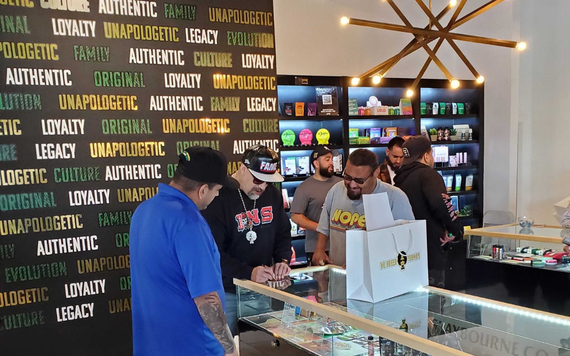 Take better care of your VIP dispensary customers blog banner image depicting B-Real signing autographs in a cannabis retail store. 